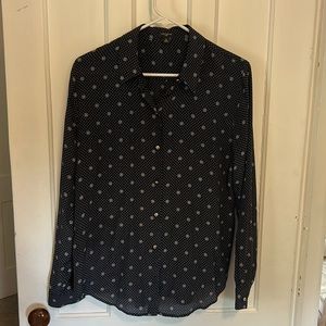 Navy blue blouse with white designs and gold buttons